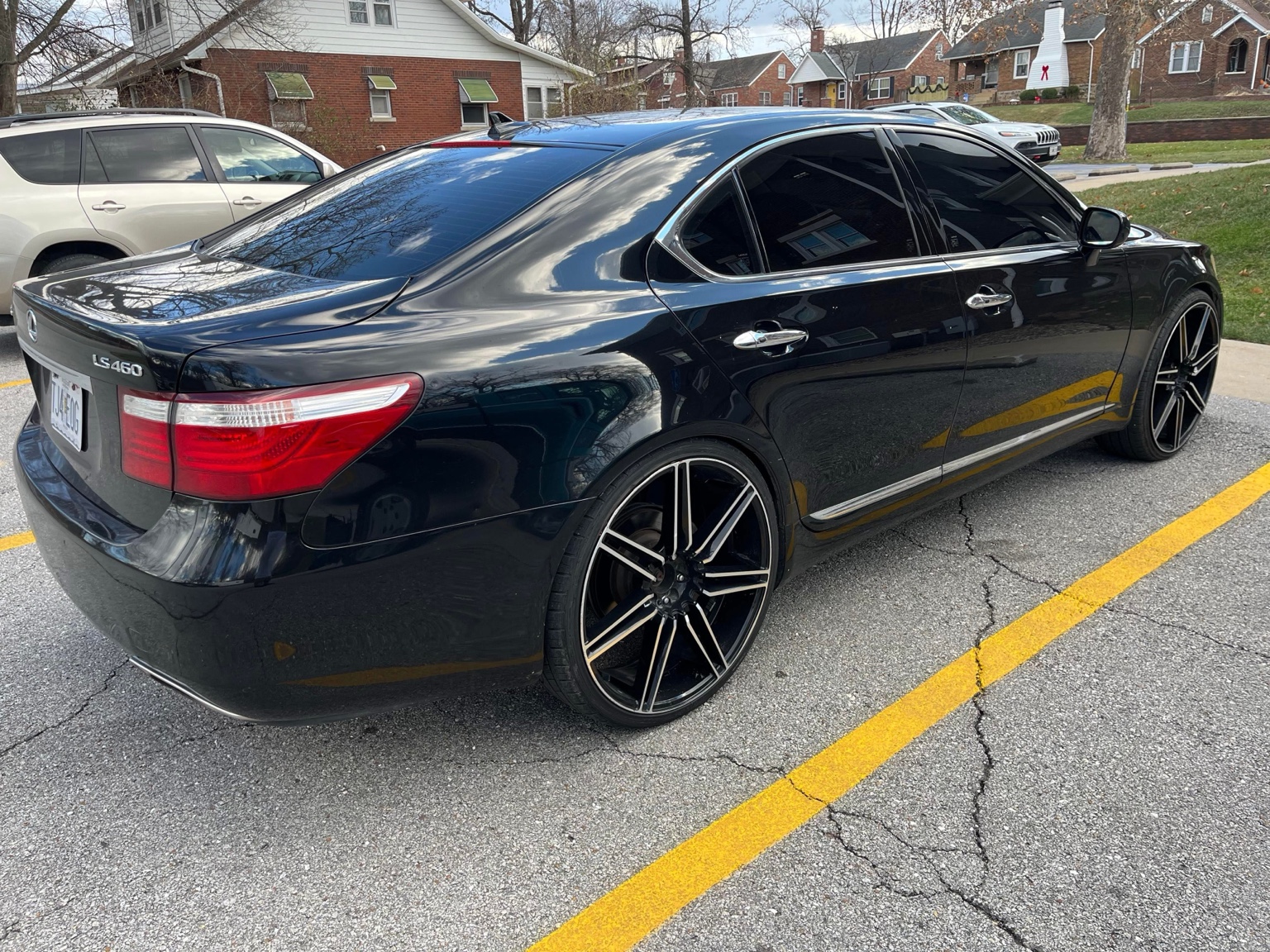 Black Lexus LS sedan with large wheels